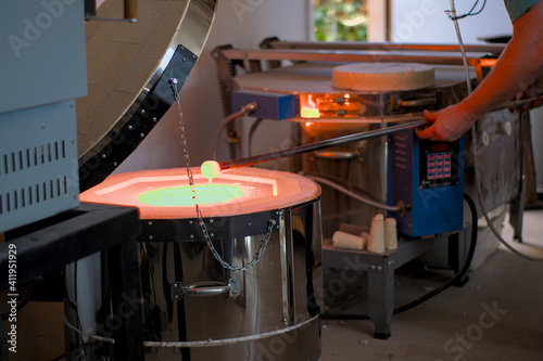 Canvas Print Gathering liquid glass from kiln onto punty to be rolled onto marver and heated in furnace and blown by gaffer shaped into art