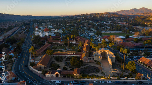 Sunset aerial view of the Spanish Colonial era mission and surrounding city of downtown San Juan Capistrano, California, USA.  © Matt Gush