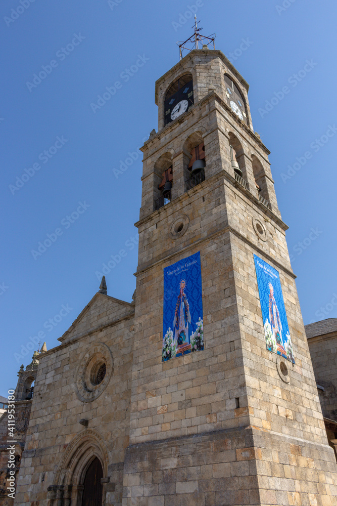 Puebla de Sanabria, Spain - September 6, 2020: Bell tower of Santa María del Azogue church (Iglesia de Nuestra Senora del Azogue) is a pretty village church that was first built in the 12th century.