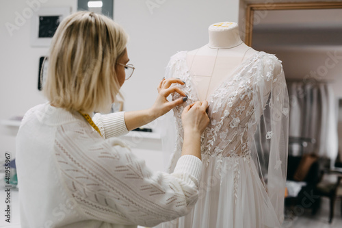 Fotografi Close-up of work process of a fashion designer at her studio