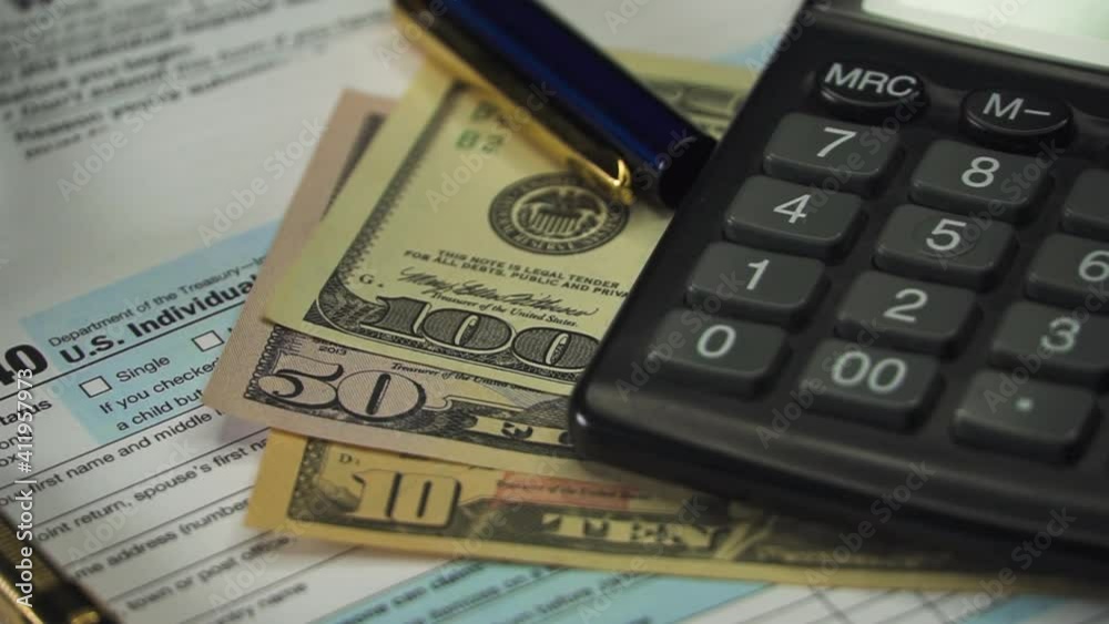Blank Form 1040 U.S. Individual Income Tax Return with Pen and banknotes. Tax Payment Concept. Filing Taxes Document Blank Form 1040 U.S. Individual Income Tax Return with Pen and banknotes. Tax Payment Concept. Filing Taxes Document