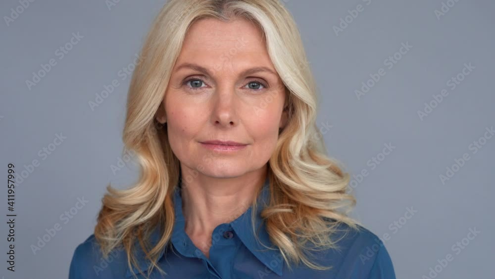 Confident smart 50s middle aged blond woman looking at camera. Mature older lady professional leader, businesswoman manager, sales representative or business coach close up face front portrait.