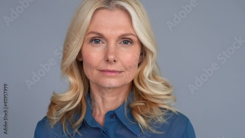 Confident smart 50s middle aged blond woman looking at camera. Mature older lady professional leader, businesswoman manager, sales representative or business coach close up face front portrait.