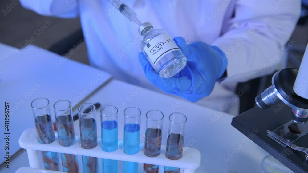 Research concept of 4k resolution. Scientists are dropping the vaccine into a test tube. Research concept of 4k resolution. Scientists are dropping the vaccine into a test tube.