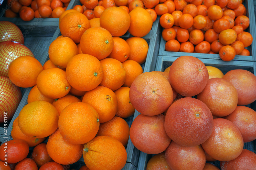 oranges, grapefruits, tangerines, pomelo in the window of the local market
