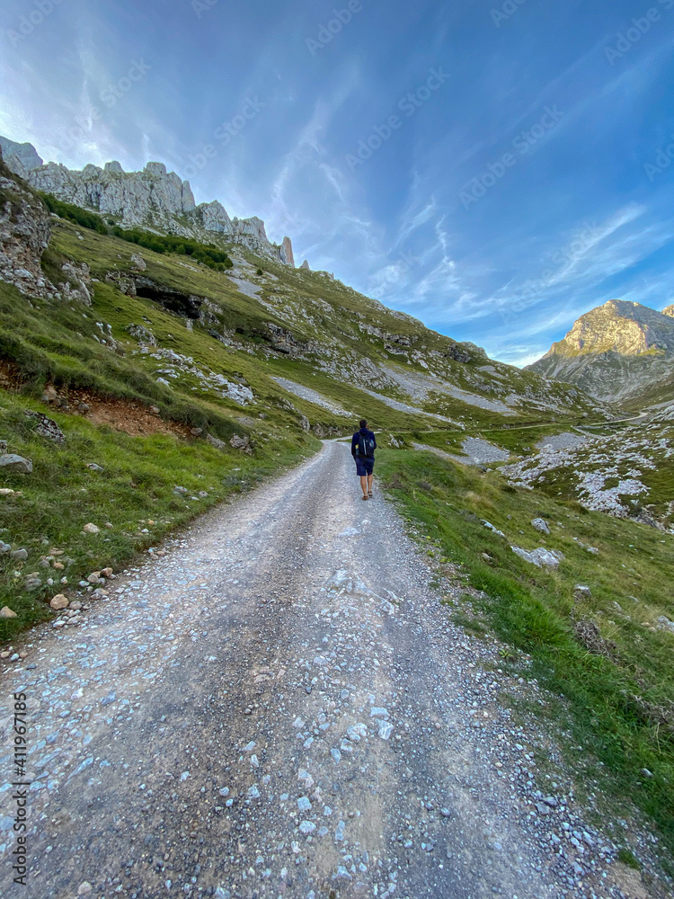 Hiker hike the Escamellau Peak. Escamellau bounds the Juan de la Cuadra range on the North, which in turn separates the Puertos de Aliva, on the East, from the Monetas valley, on the West.