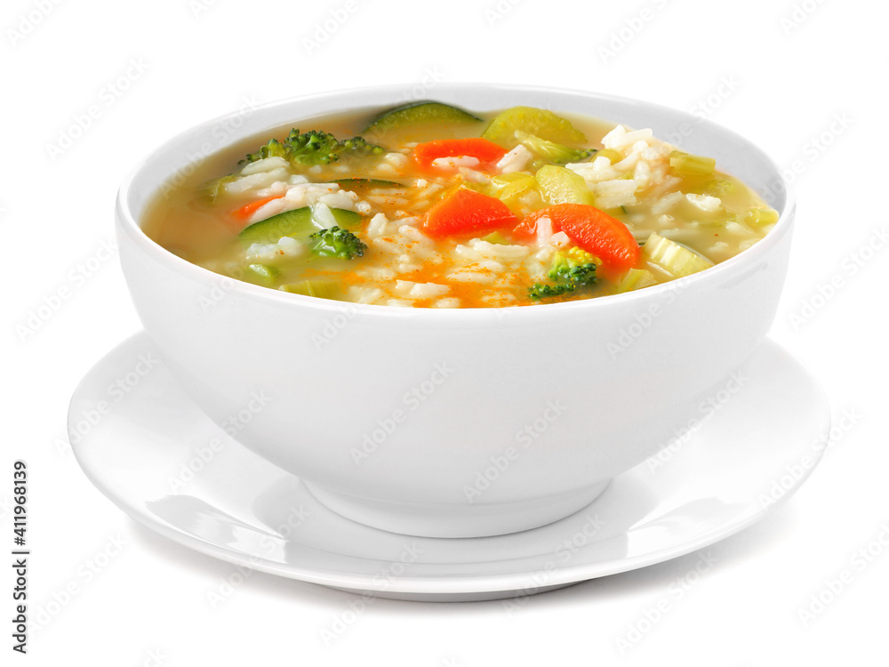 Healthy vegetable soup with rice in a white bowl with saucer. Side view isolated on a white background. Healthy vegetable soup with rice in a white bowl with saucer. Side view isolated on a white background.