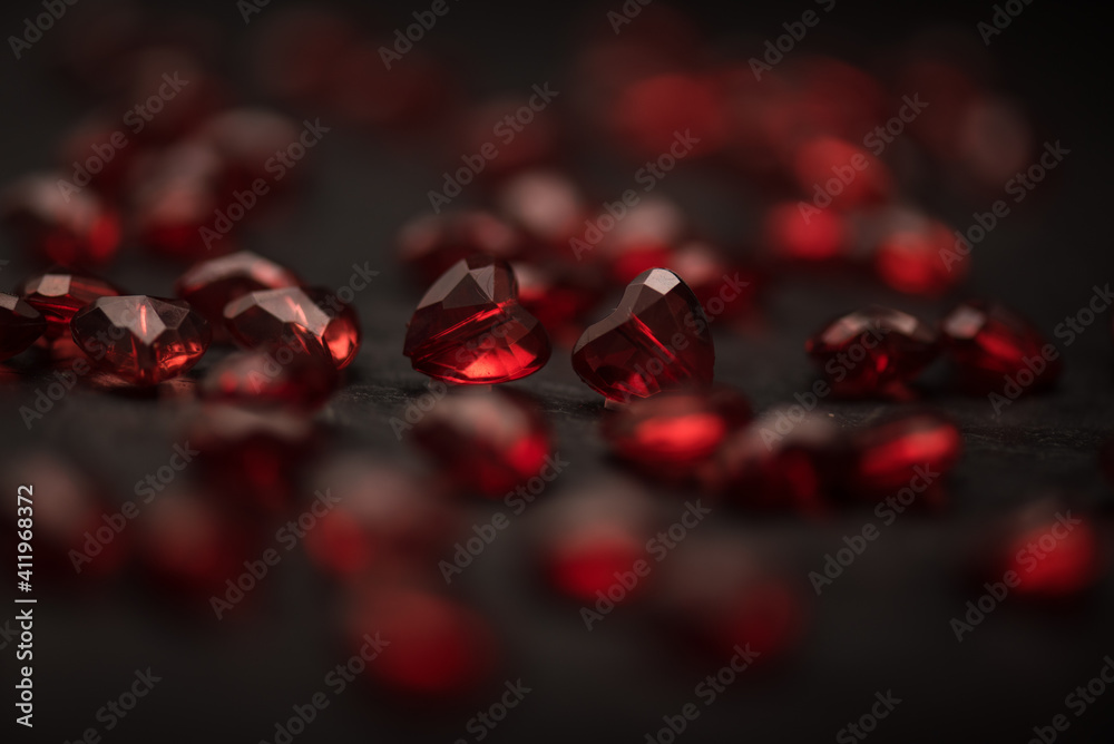Close-up on a red glass hearts on a dark background. Valentine's concept. Symbol of love and Valentine's day. Close-up on a red glass hearts on a dark background. Valentine's concept. Symbol of love and Valentine's day.
