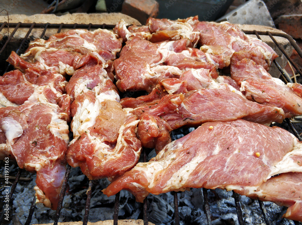 Smoky barbecue on the grill outside. The meaty taste of spring