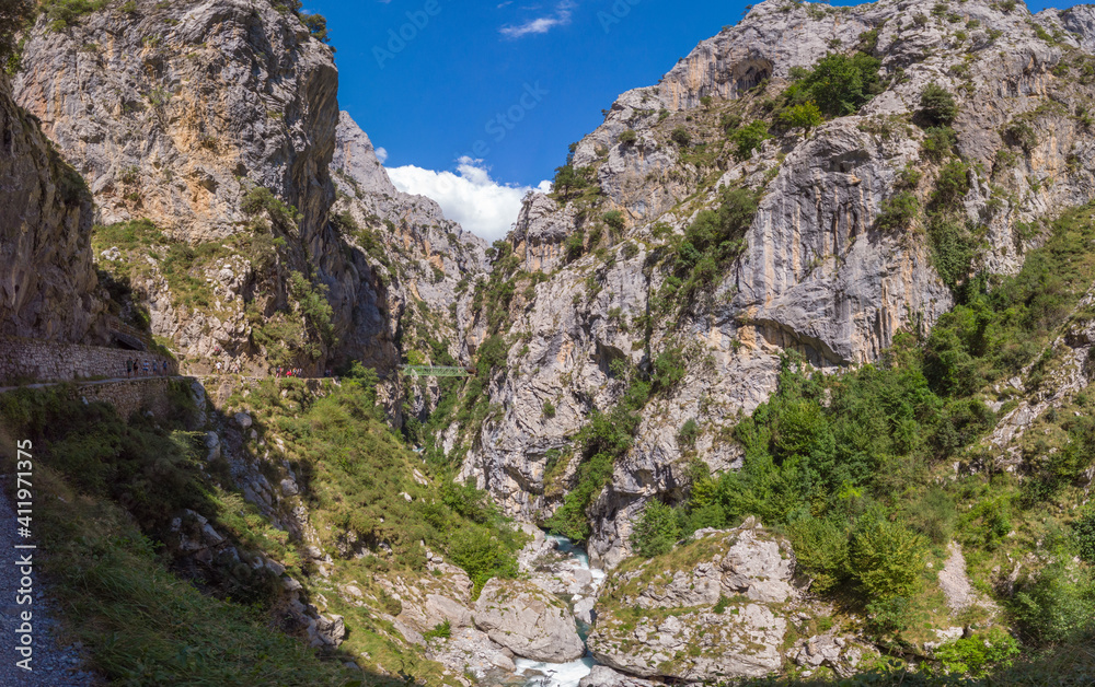 Panoramic of the Cares Route in the heart of Picos de Europa National Park, Cain-Poncebos, Asturias, Spain. Narrow and impressive canyon between cliffs, bridges, caves, footpaths and rocky mountains.