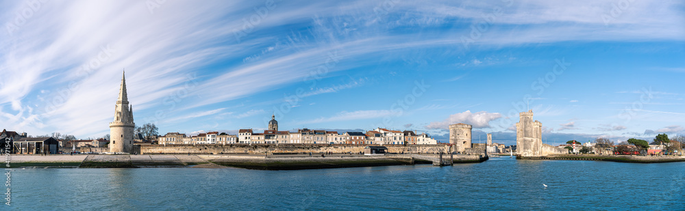 Panoramic view of the old harbor of La Rochelle with old towers on a sunny day