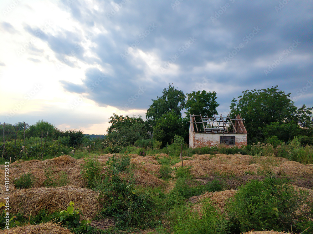 An abandoned house with a dismantled roof in a village