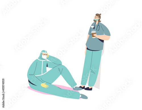 Tired doctor and nurse in protective uniform and masks overworked during covid pandemic