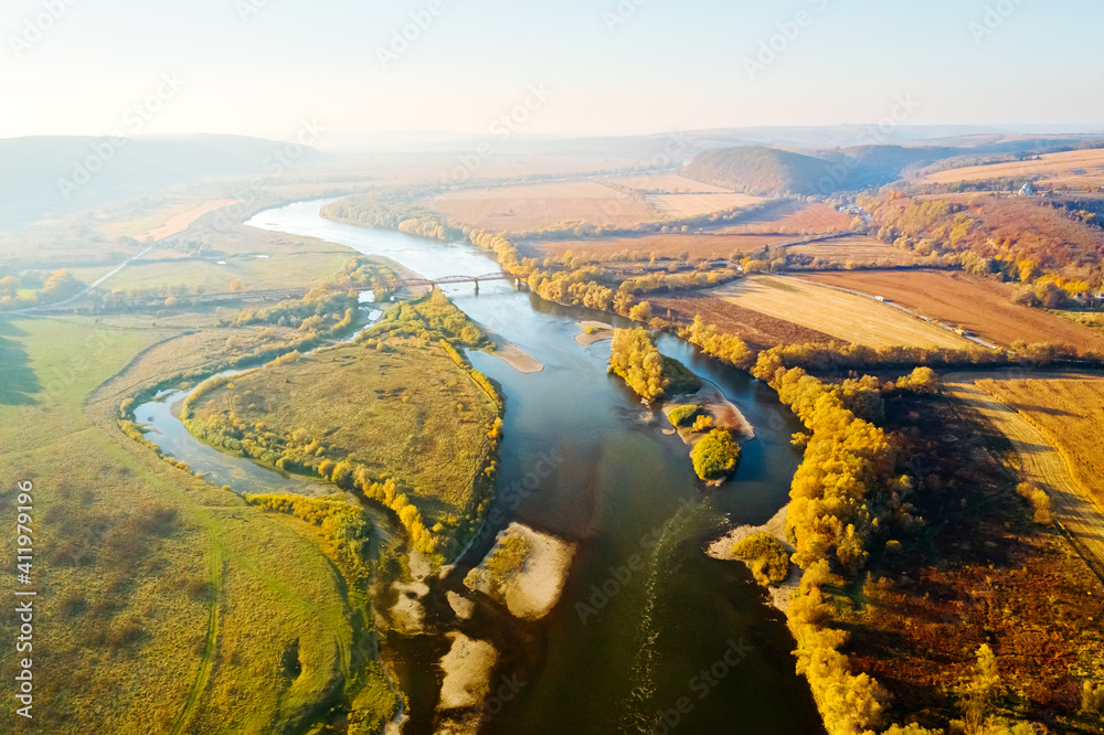 Aerial top view of winding river in sunny day.