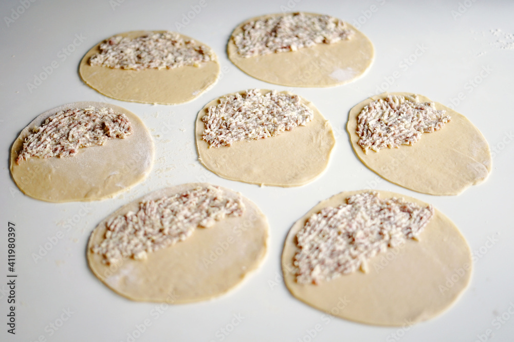 dough for pasties minced meat on the cooking table
dough for pasties minced meat on the cooking table