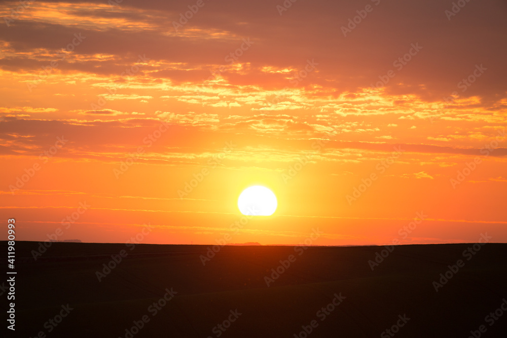 Magical colorful sunset with red scenic clouds.