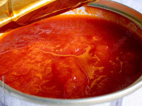 Macro view of fried tomato in a can. Ingredient in high resolution