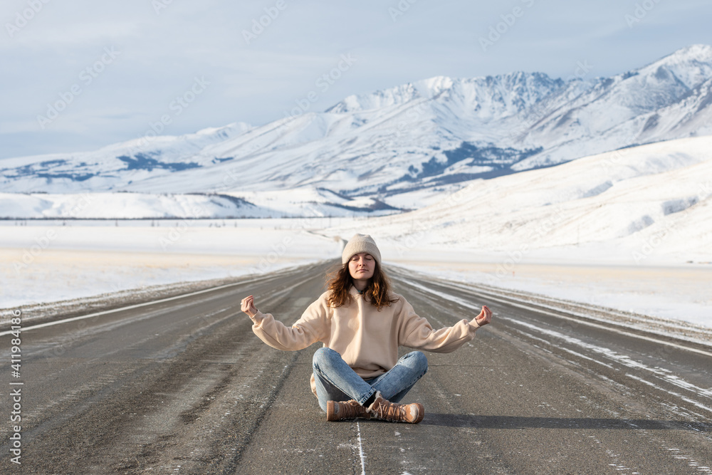 Young woman meditating on the road