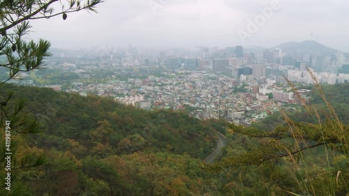 Static camera. From a hill top far away, wide angle view of a typical, extremely polluted and thickly inhabited korean city landscape. photo