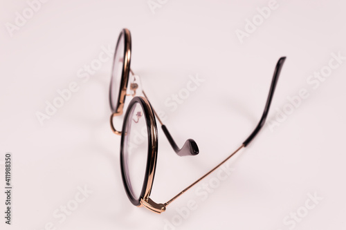 side view of glasses that lie vertically with one arm slightly extended and the other folded