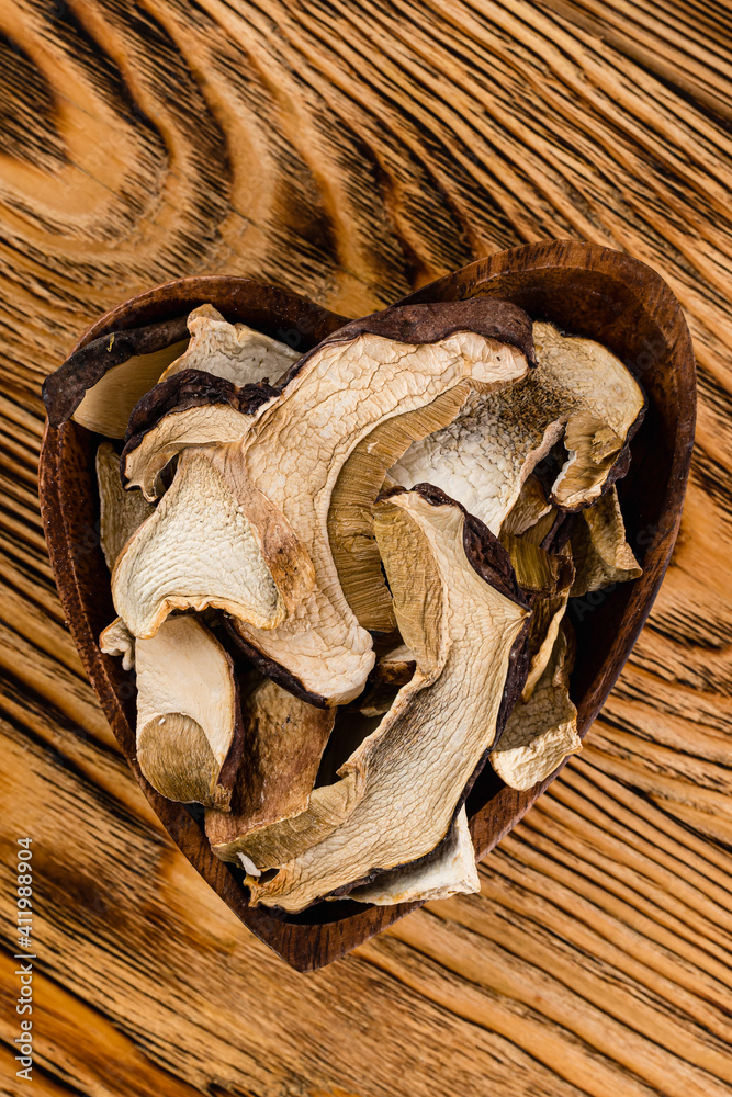 dry porcini mushrooms in a wooden bowl
