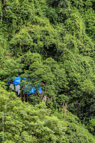 A Small Hut for One of the Temple Caretakers Is Hidden in the Green Foliage Covering the Mountains at the Perfume Pagoda outside of Hanoi, Vietnam
