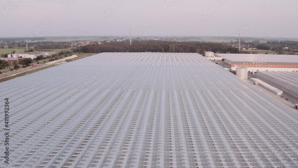Modern farming concept. Aerial view of big glasshouse. Environmental friendly farming, huge plantation, future agriculture. Modern farming concept. Aerial view of big glasshouse. Environmental friendly farming, huge plantation, future agriculture.