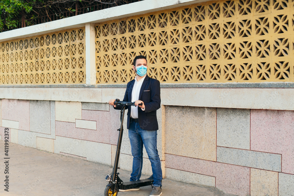 Masked man driving an electric scooter during the pandemic
