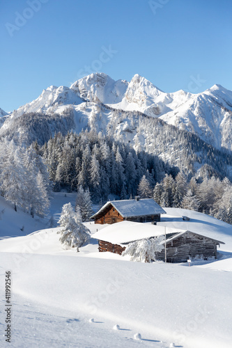 Beautiful winter mountain landscape with snowcapped wooden chalet