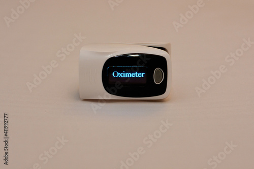 fingertip pulse oximeter medical equipment that measures oxygen saturation in blood and heart rate 