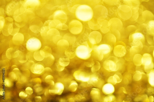 Gold defocused glitter. Bokeh light of gold glitters background. 