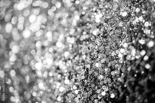 Silver defocused glitter. Bokeh light of gold glitters background. 