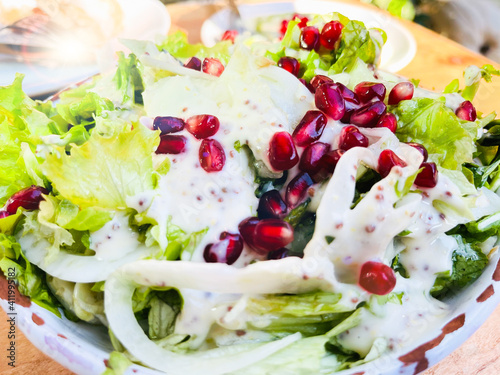  Close up healthy salad of fresh vegetables and pomegranate seeds.