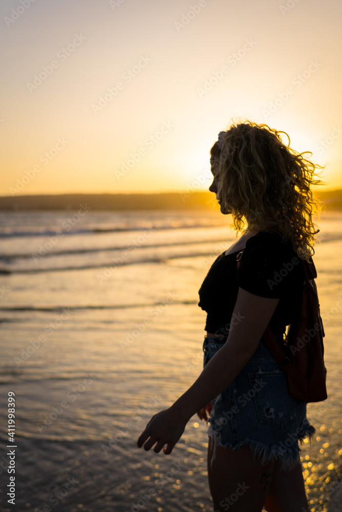 woman in a sunset beach woman in a sunset beach