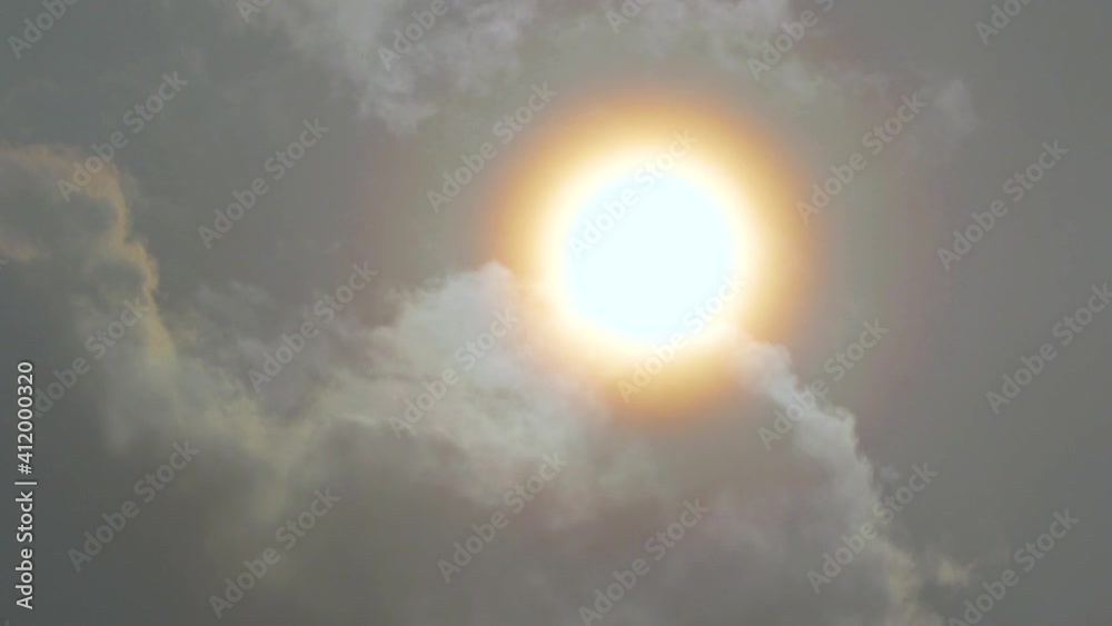 Clouds moving away from the gold colored sun Clouds moving away from the gold colored sun