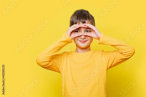 Billede på lærred Portrait happy child boy looking, observing, keeping an eye on an object in front, or watching out for something