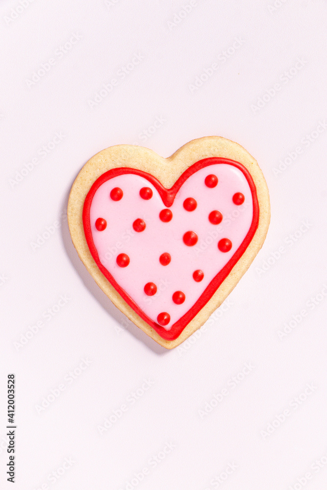 close up of a homemade heart shaped valentines sugar cookie with colorful icing