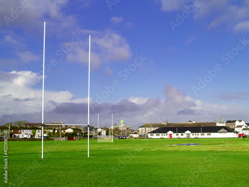 Irish sport tall goal posts in a field on a bright sunny day. Galway city, Ireland. South park. Camogie, hurling and rugby training ground. Blue cloudy sky. Selective focus