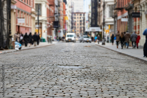 Greene Street is crowded with busy people in the SoHo neighborhood of Manhattan, New York City