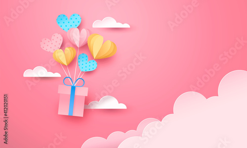 Pink paper gift box flying in sky heart balloon