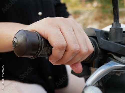 closeup of woman hand on handle motorcycle bar.