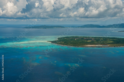 Exceptional view of Kuro island and coral reefs with its clear blue and green waters seen from the plane.