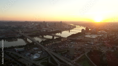Downtown Cincinnati skyline sunrise aerial view looking out over the Brent Spence Bridge during rush hour traffic. 