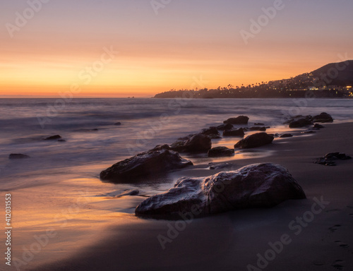 Sunset over rocks on Laguna Beach shore