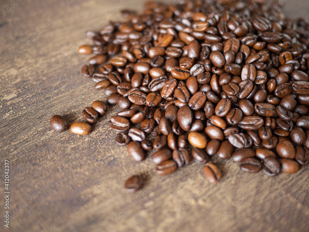Coffee beans on wood table background Coffee beans on wood table background