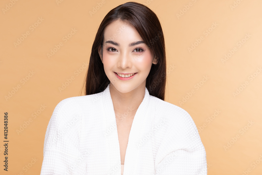 Beautiful Asian woman wearing bathrobe smile with clean and fresh skin Happiness and cheerful with positive emotional,isolated on Beige background,Beauty Cosmetics and spa Treatment Concept Beautiful Asian woman wearing bathrobe smile with clean and fresh skin Happiness and cheerful with positive emotional,isolated on Beige background,Beauty Cosmetics and spa Treatment Concept