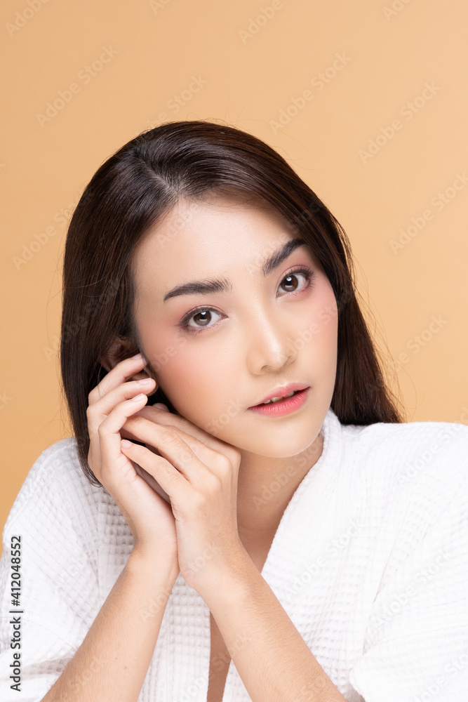Beautiful Asian woman wearing bathrobe smile with clean and fresh skin Happiness and cheerful with positive emotional,isolated on Beige background,Beauty Cosmetics and spa Treatment Concept Beautiful Asian woman wearing bathrobe smile with clean and fresh skin Happiness and cheerful with positive emotional,isolated on Beige background,Beauty Cosmetics and spa Treatment Concept