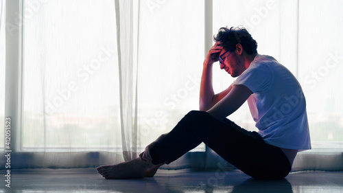 Obraz na plátně man sitting alone at home looking sorrow with desperate and depressed