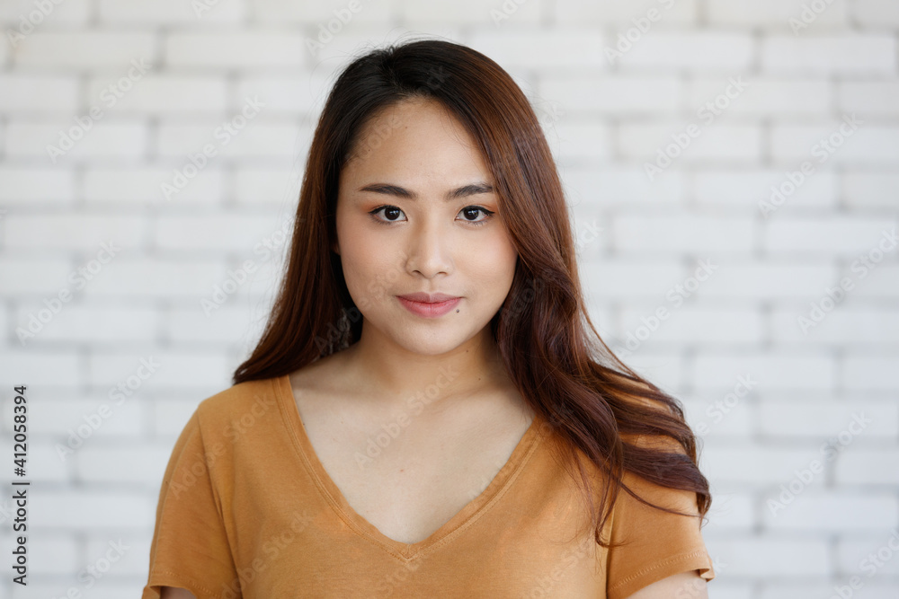Young and beautiful healthy Asian woman with a mole on face and positive happy pose on a plain background. Concept for joy, proud, self-confident, and successful female in business and life Young and beautiful healthy Asian woman with a mole on face and positive happy pose on a plain background. Concept for joy, proud, self-confident, and successful female in business and life