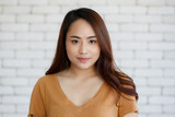 Young and beautiful healthy Asian woman with a mole on face and positive happy pose on a plain background. Concept for joy, proud, self-confident, and successful female in business and life
